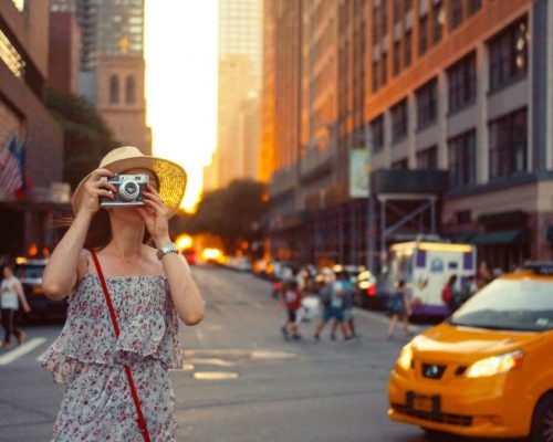 Young photographer with a retro camera in New York
