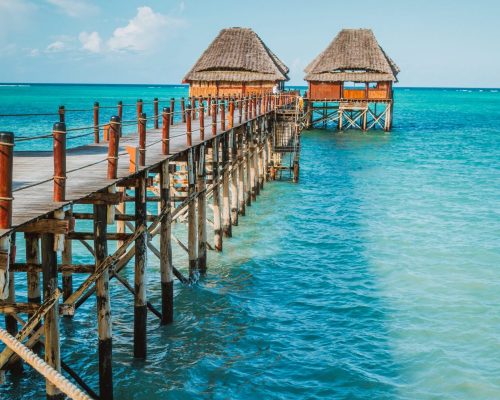 Thatched huts on wooden pier, Zanzibar Island